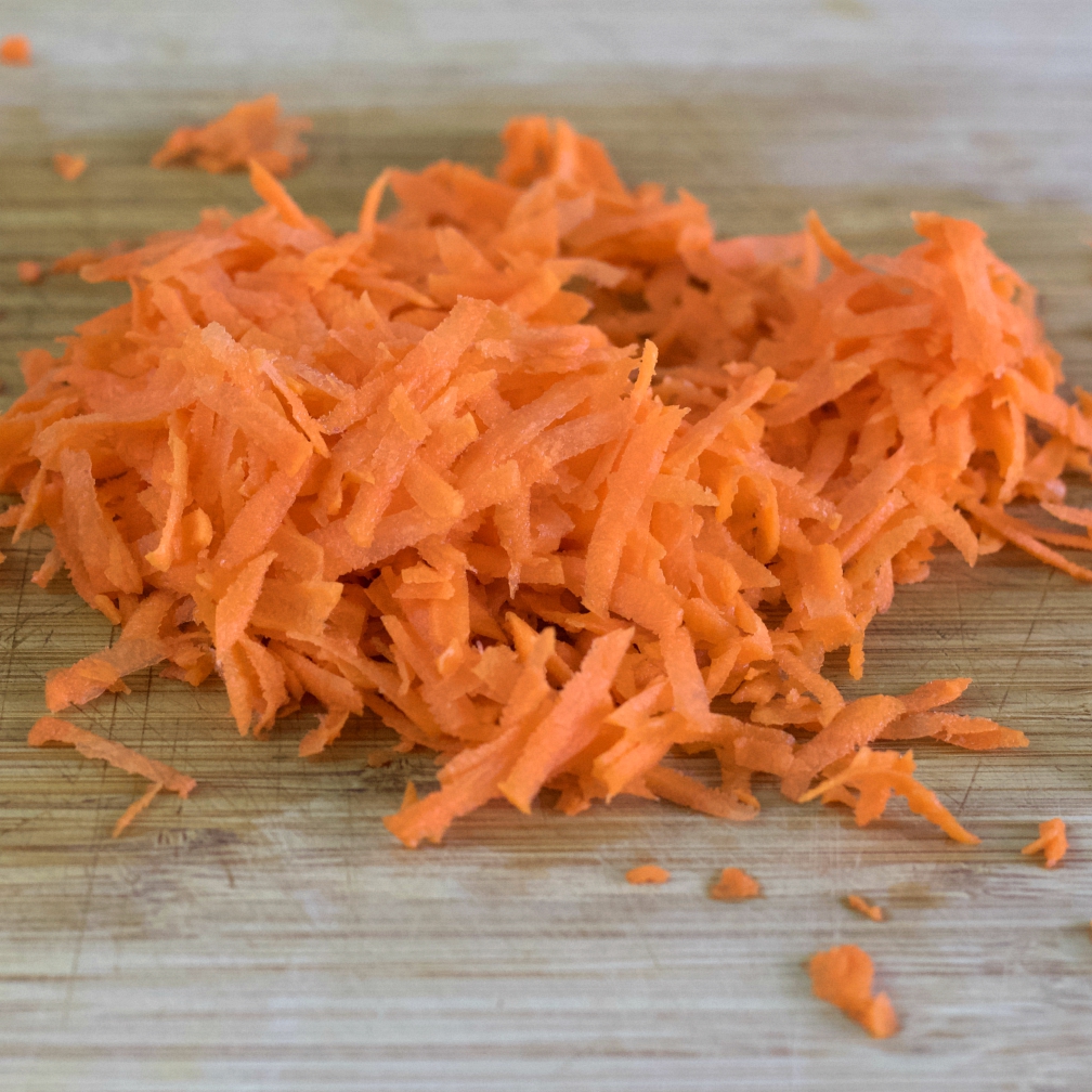 grated carrots on a wooden board