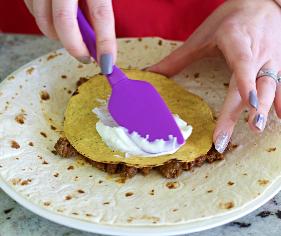 spread sour cream on tostada