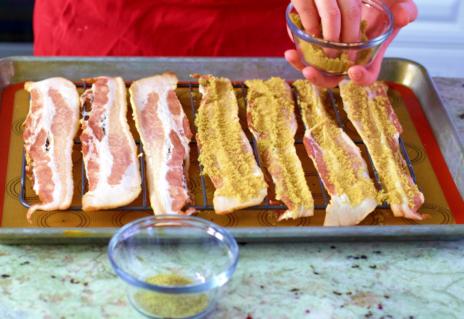 spreading brown sugar on raw bacon
