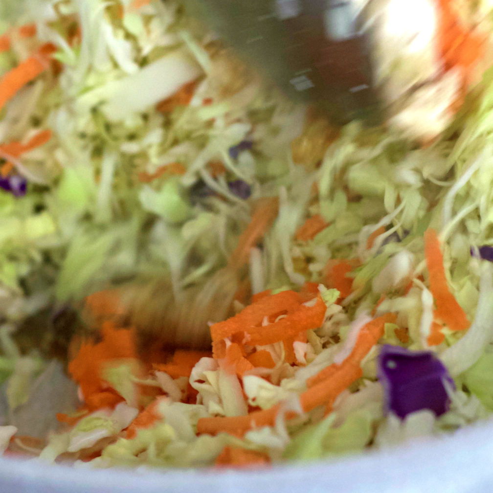 stirring egg rolls in a bowl