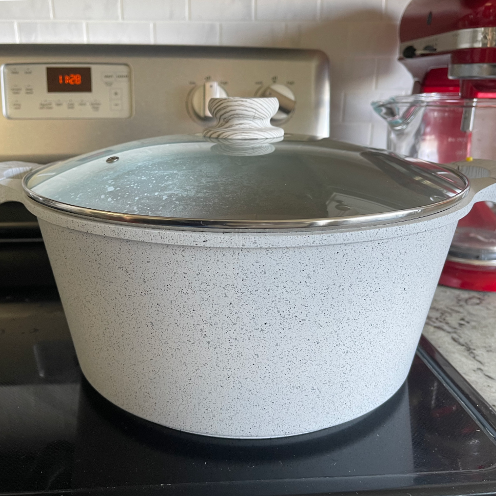 covered pot of chili simmering on the stove