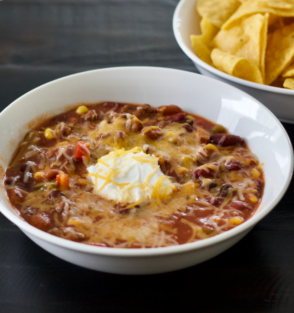 chili with sour cream and cheddar cheese on top. Served with tortilla chips