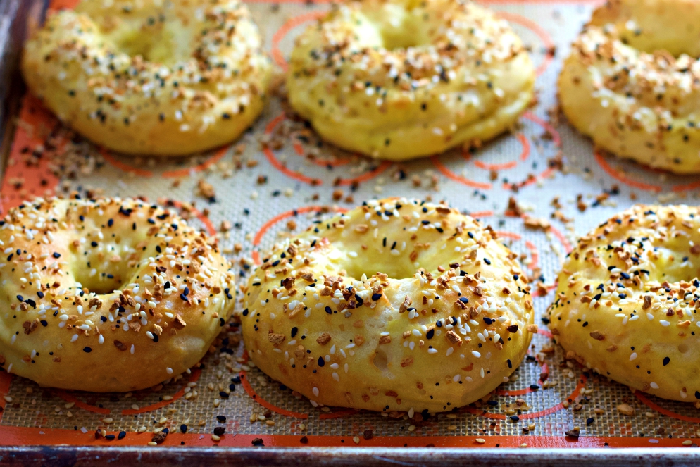 fresh baked bagels on baking sheet