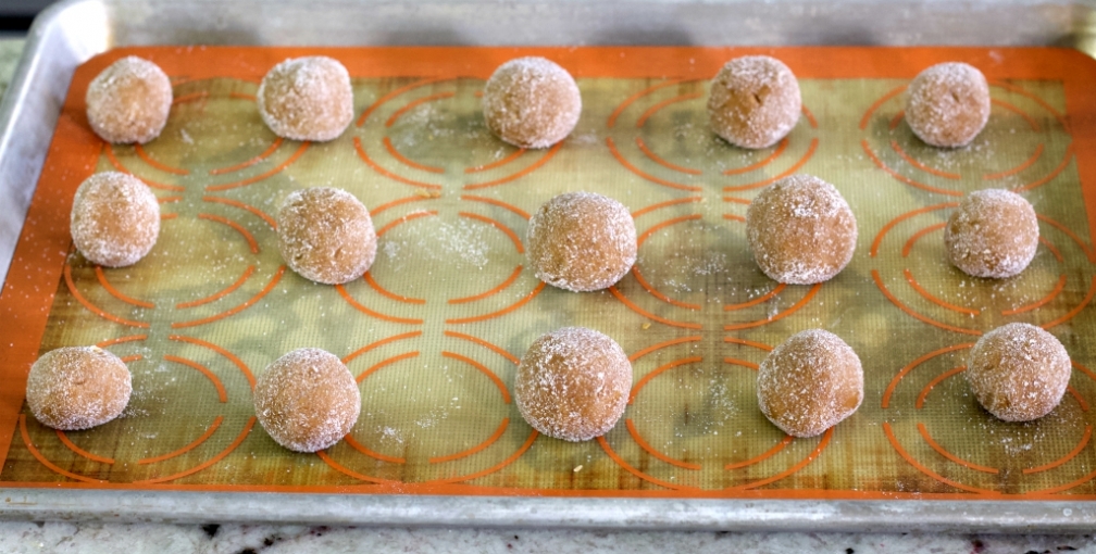 gingerbread cookie dough balls on baking sheet