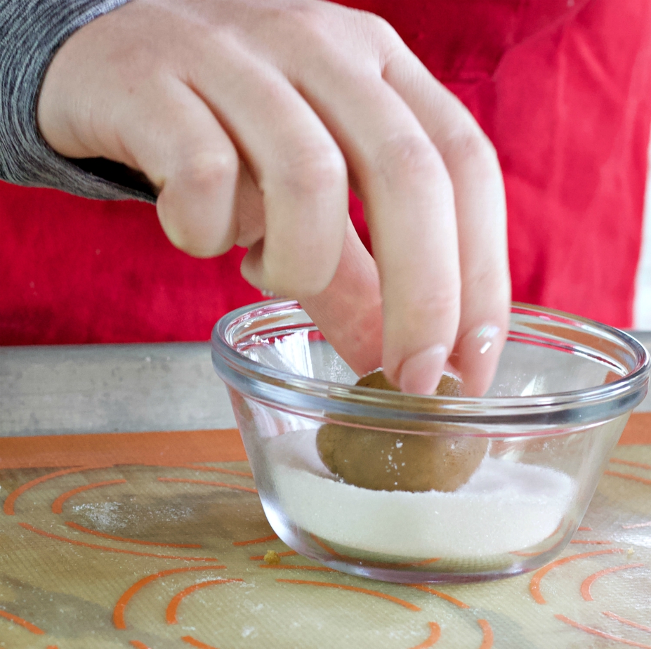 rolling gingerbread cookie dough in sugar