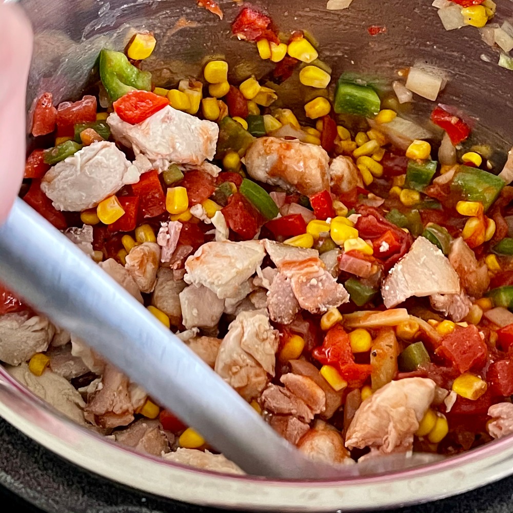 stirring stuffed pepper soup with chicken and bacon