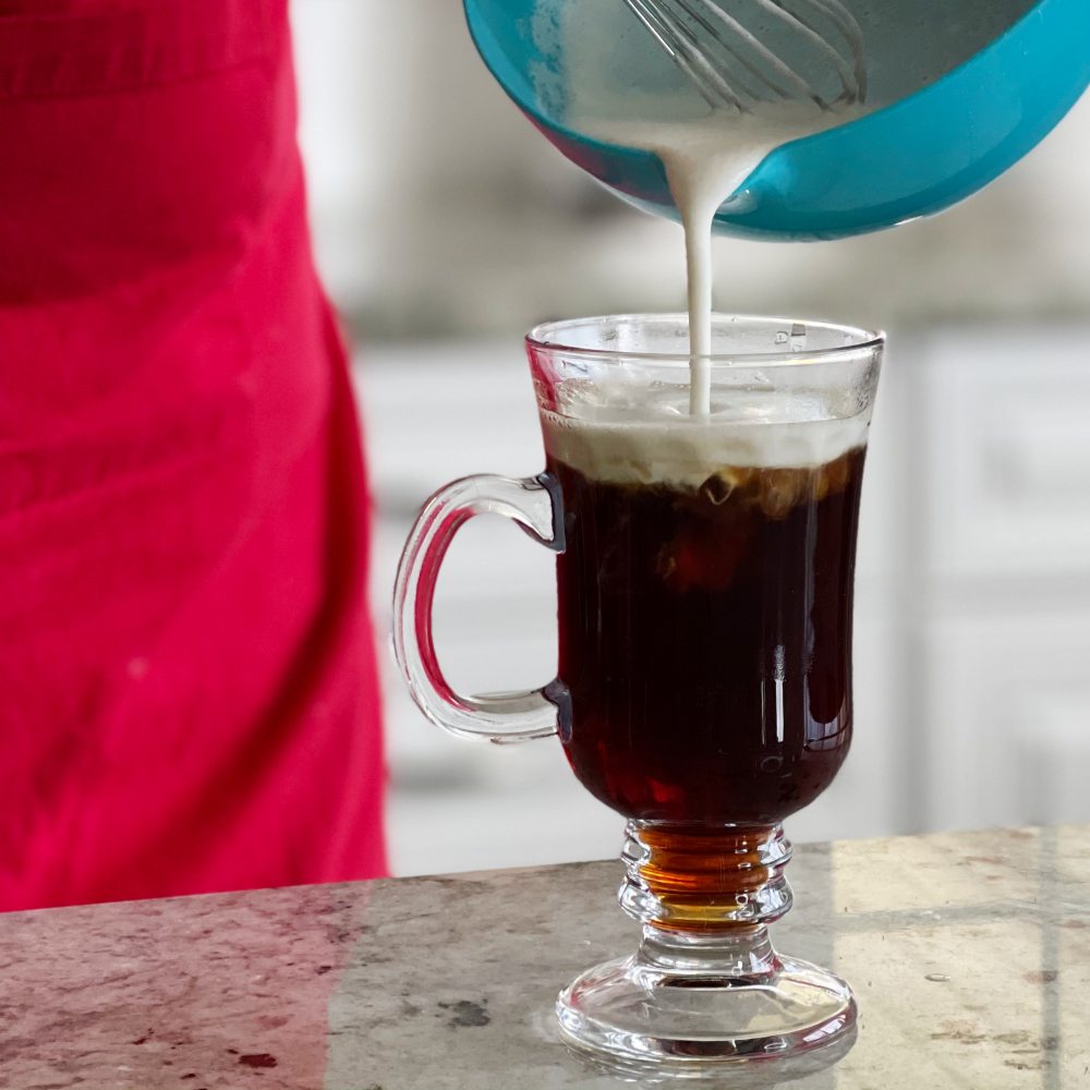 pouring cream on coffee