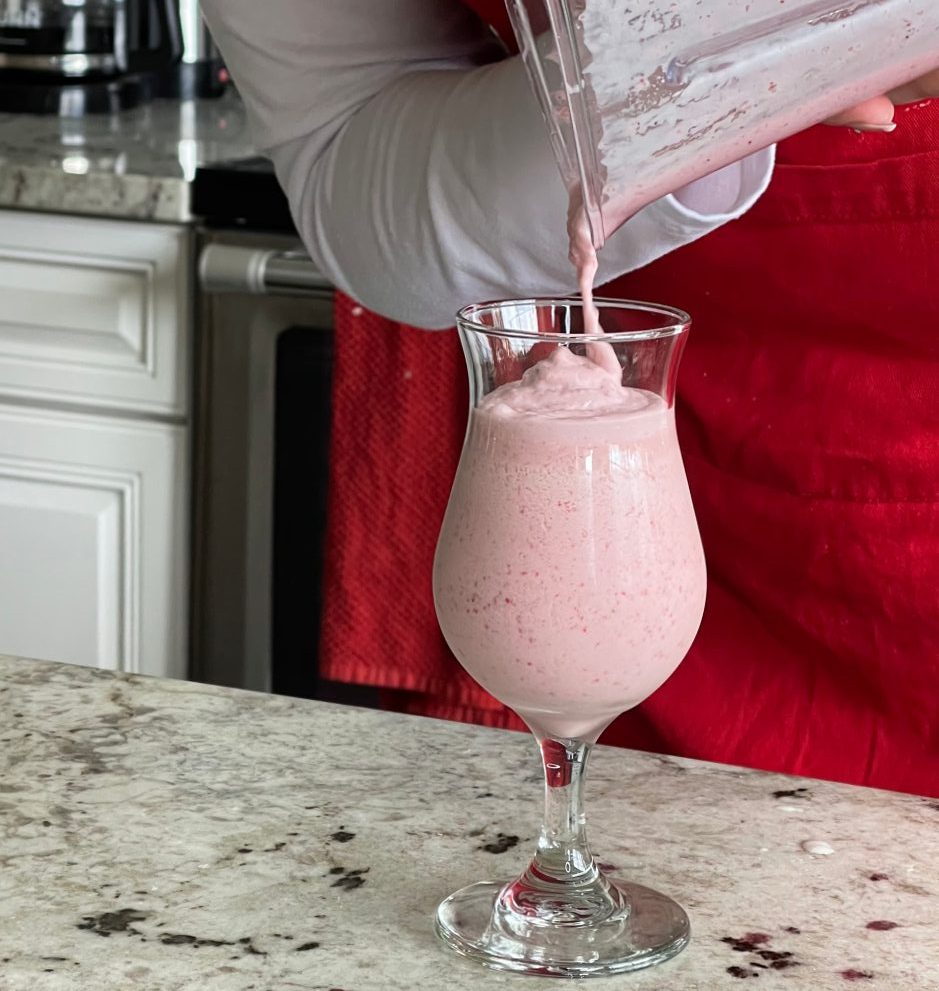 pouring boozy strawberry shake