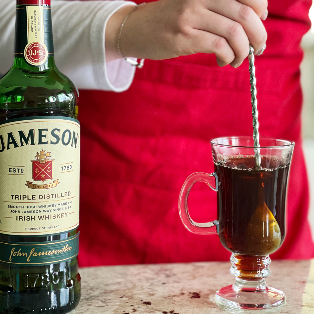 stirring jameson and sugar into coffee