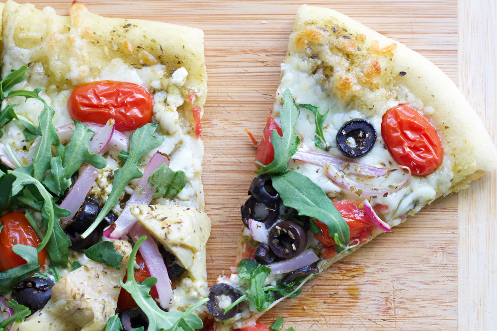 Flatbread with Mediterranean toppings cut slice