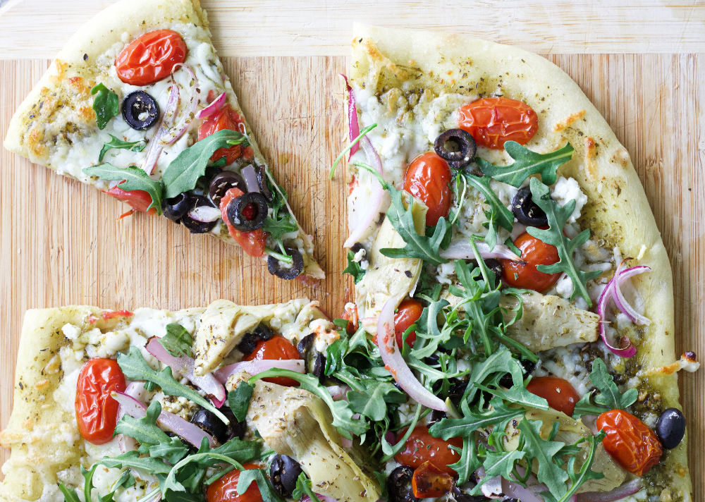 Flatbread with Mediterranean toppings cut slice