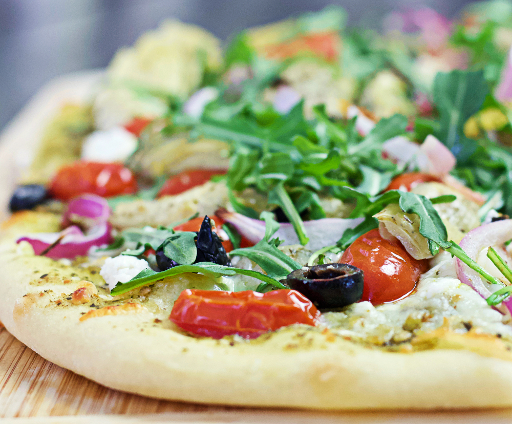 Flatbread with Mediterranean toppings cut slice