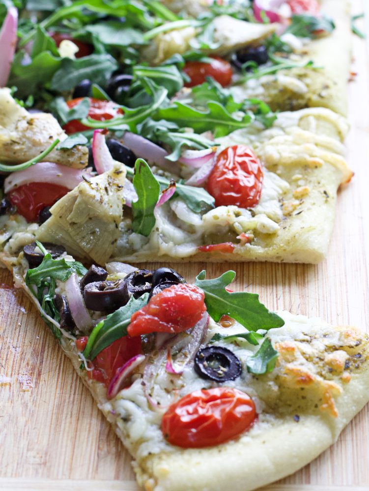 Flatbread with Mediterranean toppings cut slice-pin