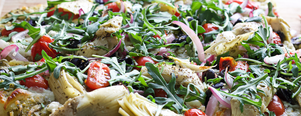 Flatbread with Mediterranean toppings close up