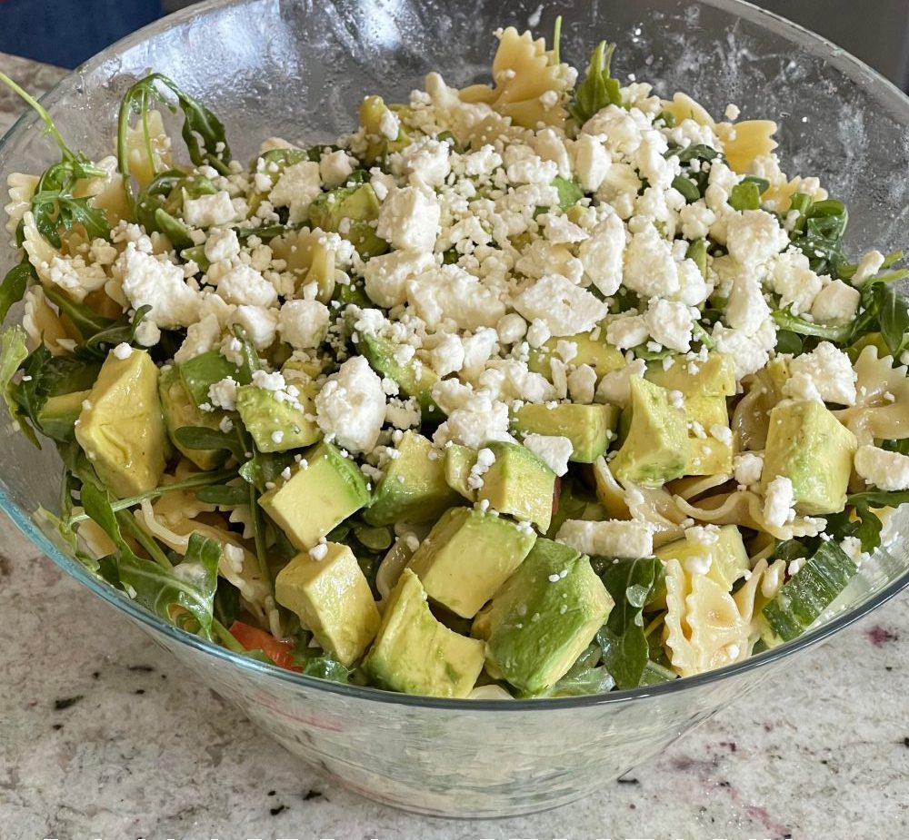 adding Feta and dressed chopped avocado