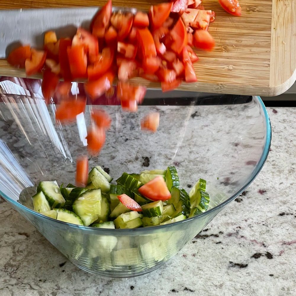 assembling Mediterranean pasta salad