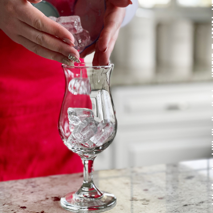 pouring ice in daiquiri glass