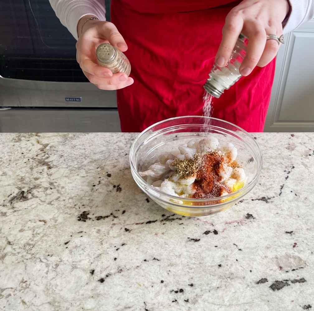 Mediterranean Shrimp Sheet Pan Dinner 15 adding salt and pepper to shrimp