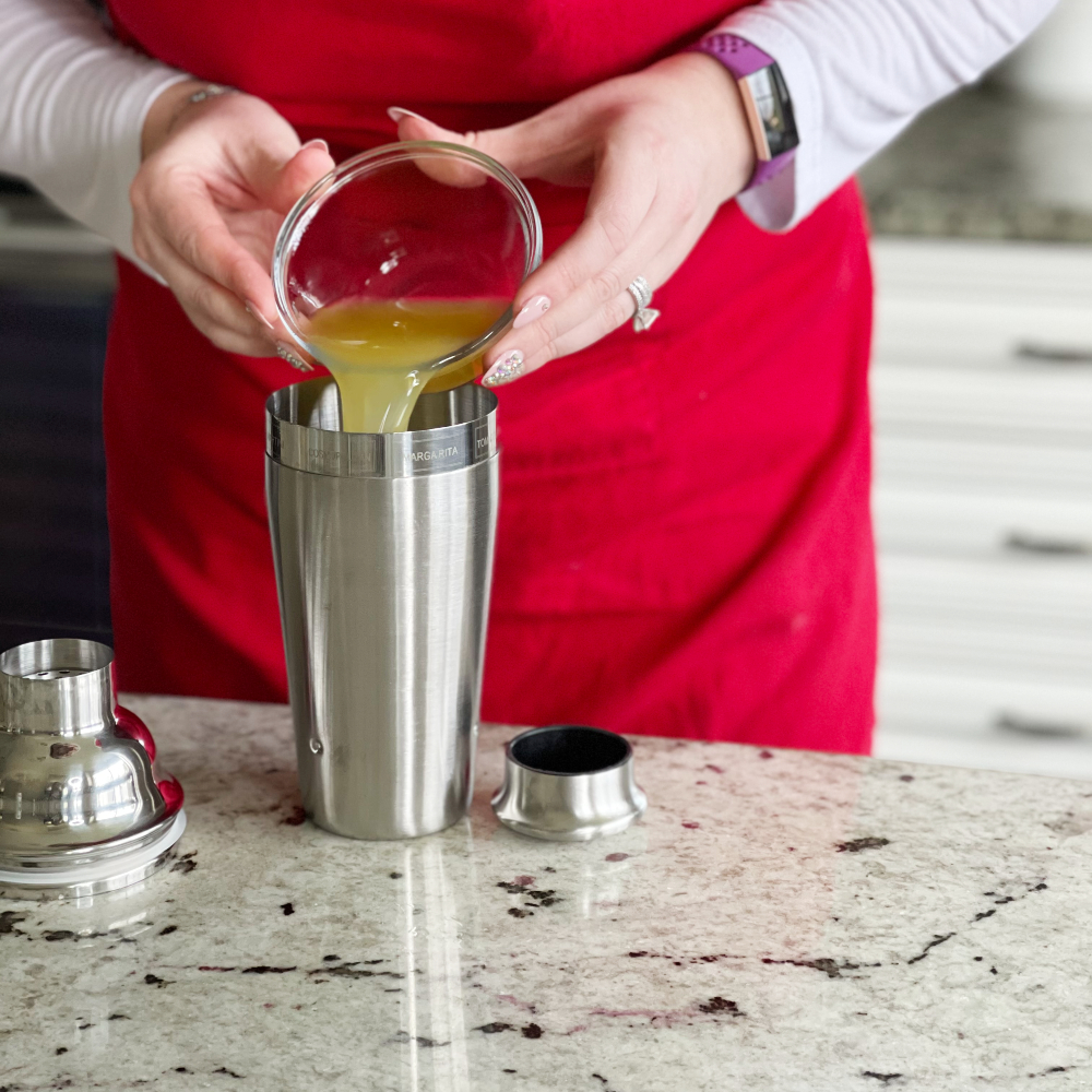 pouring juice into a shaker