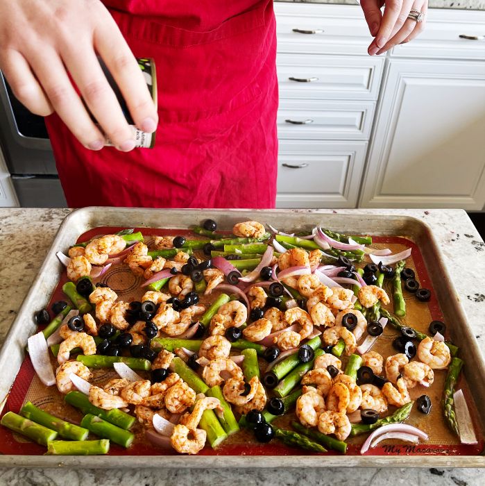 Mediterranean Shrimp Sheet Pan Dinner 20 sprinkling sliced olives over baked shrimp sheet pan dinner