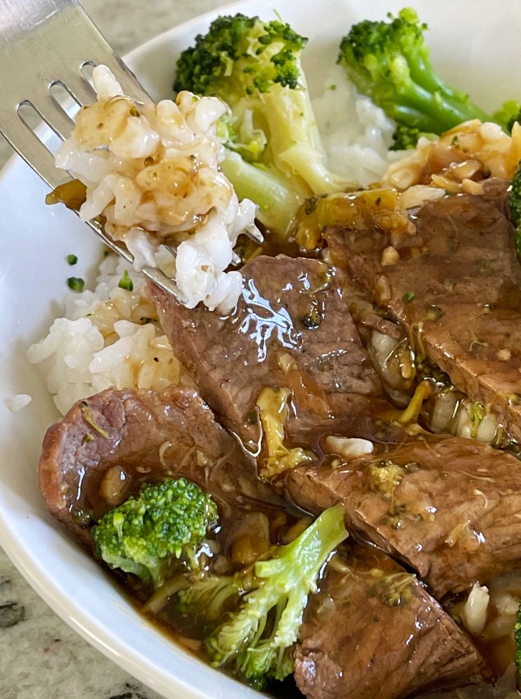 forkful of rice with asian sauce beef and broccoli recipe