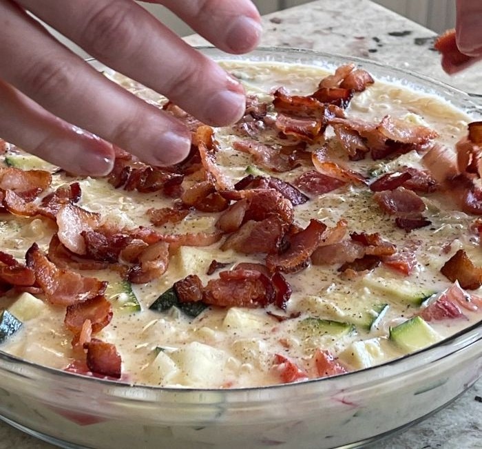 adding bacon to zucchini pie top