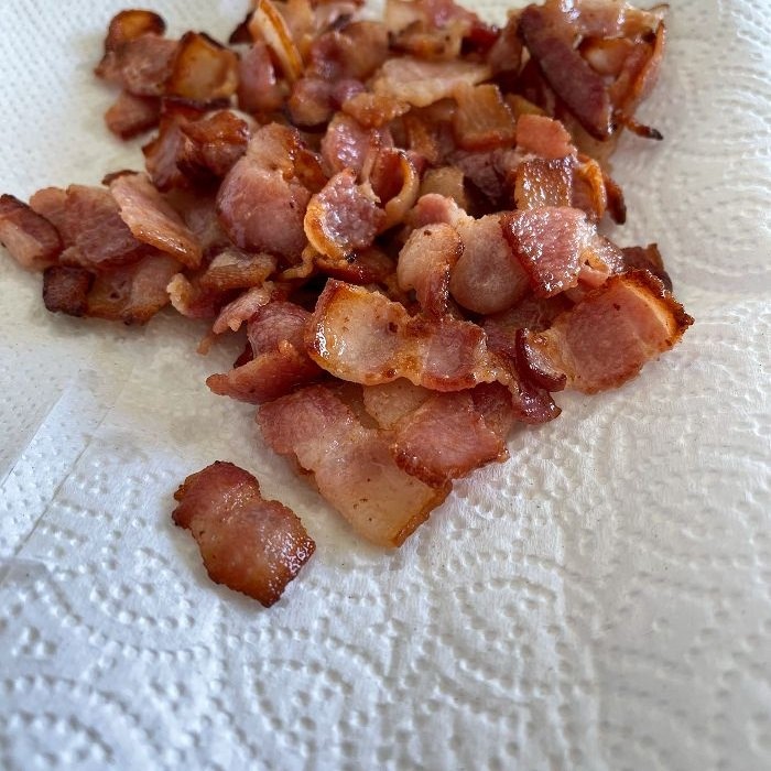cooked bacon-draining on a paper towel