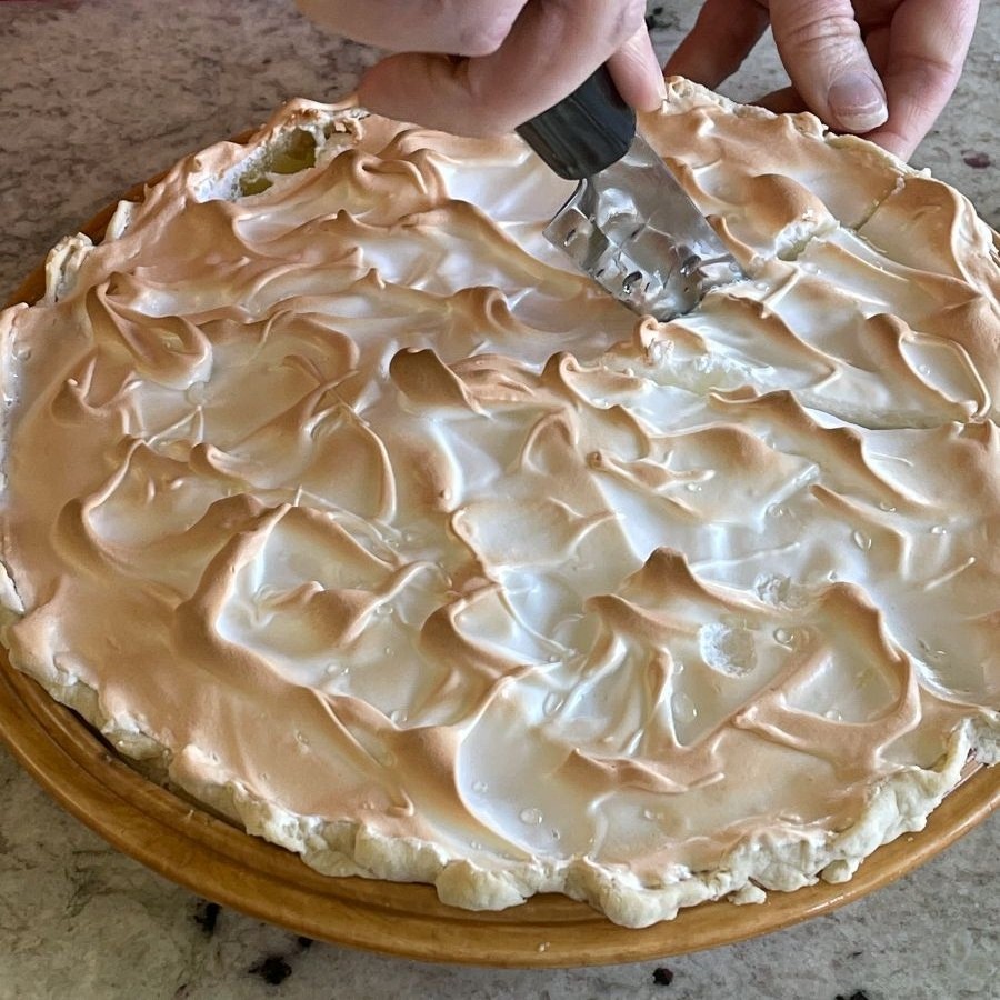 cutting lemon meringue pie