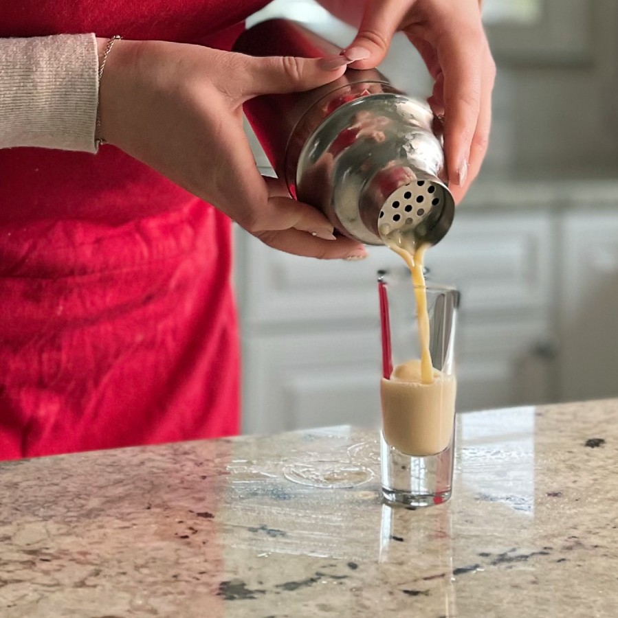pouring butterscotch shot into shot glass