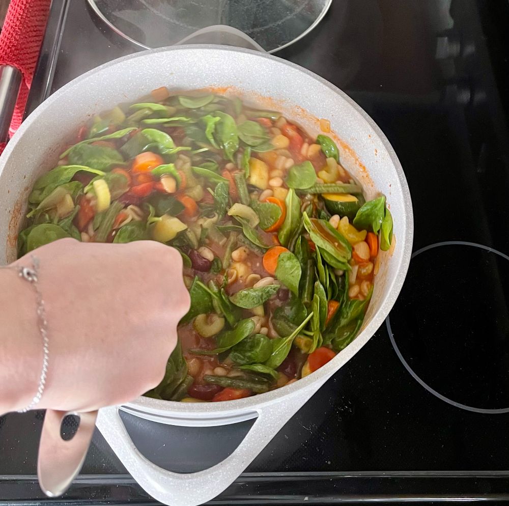 stirring minestrone soup