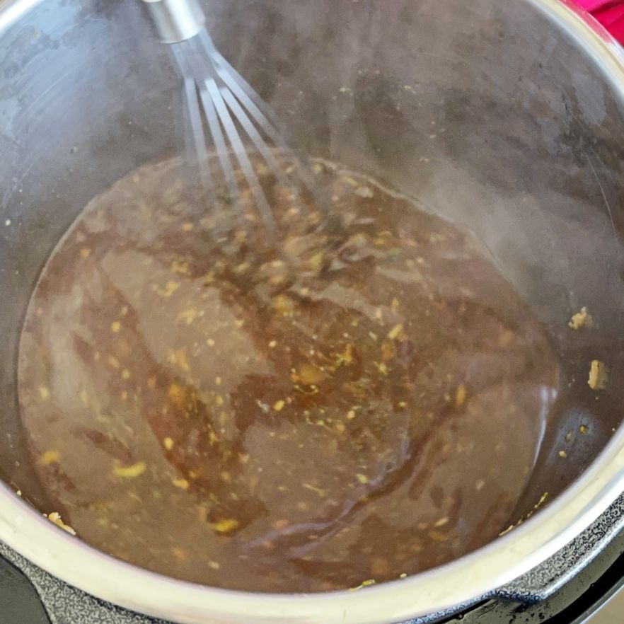 whisking savory beef and broccoli sauce