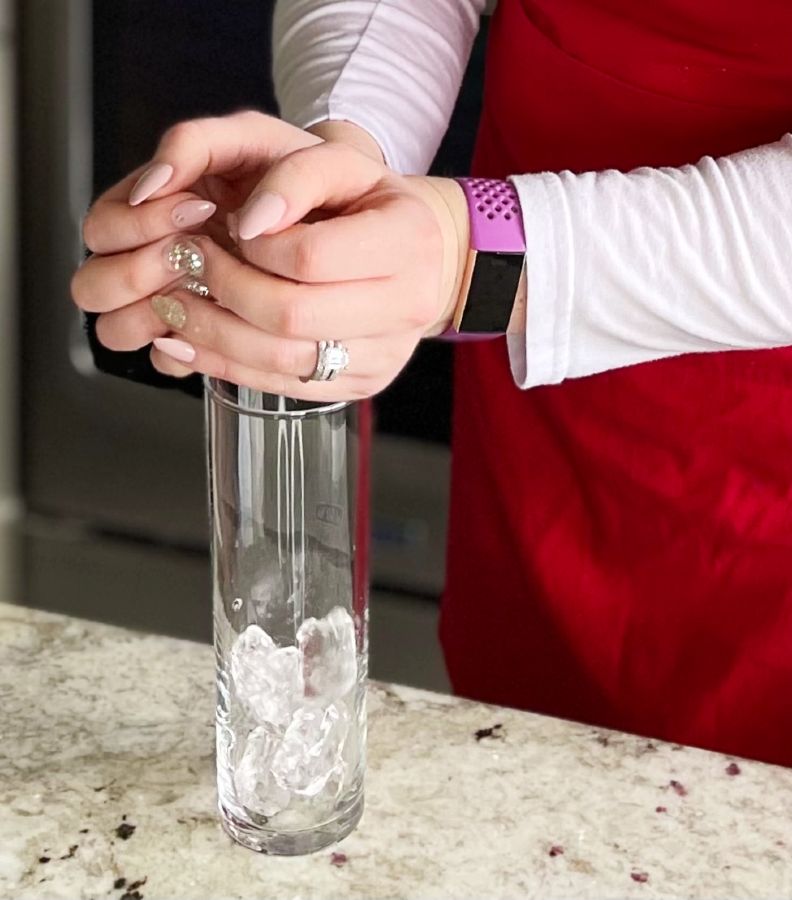 adding ice to glass