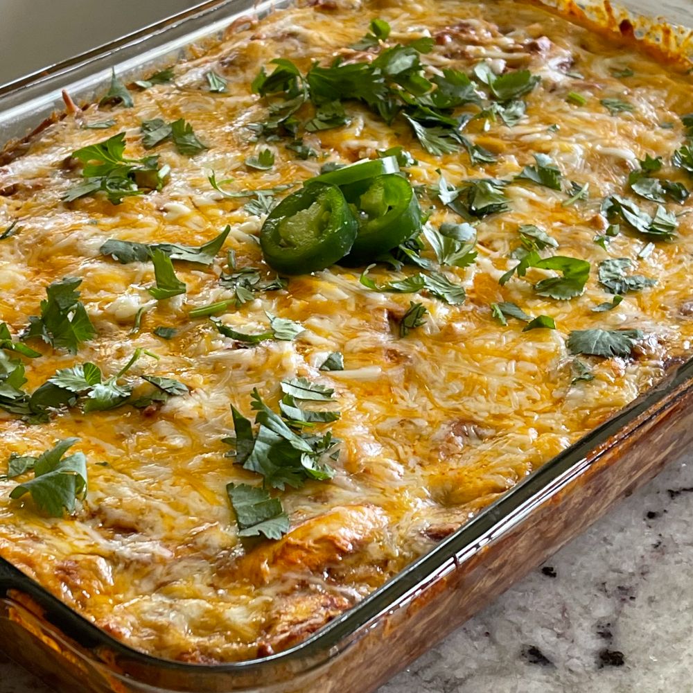 chicken enchilada casserole with cilantro and jalape&ntilde;o for garnish
