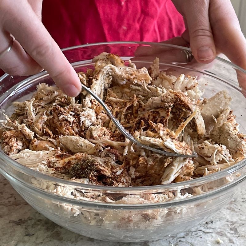 stirring chicken and spices mixture