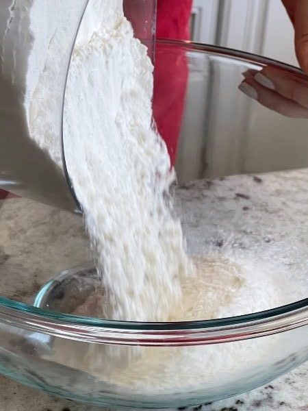 pouring dry ingredients into bowl