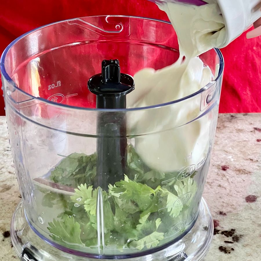 adding ingredients into food processor-sauce