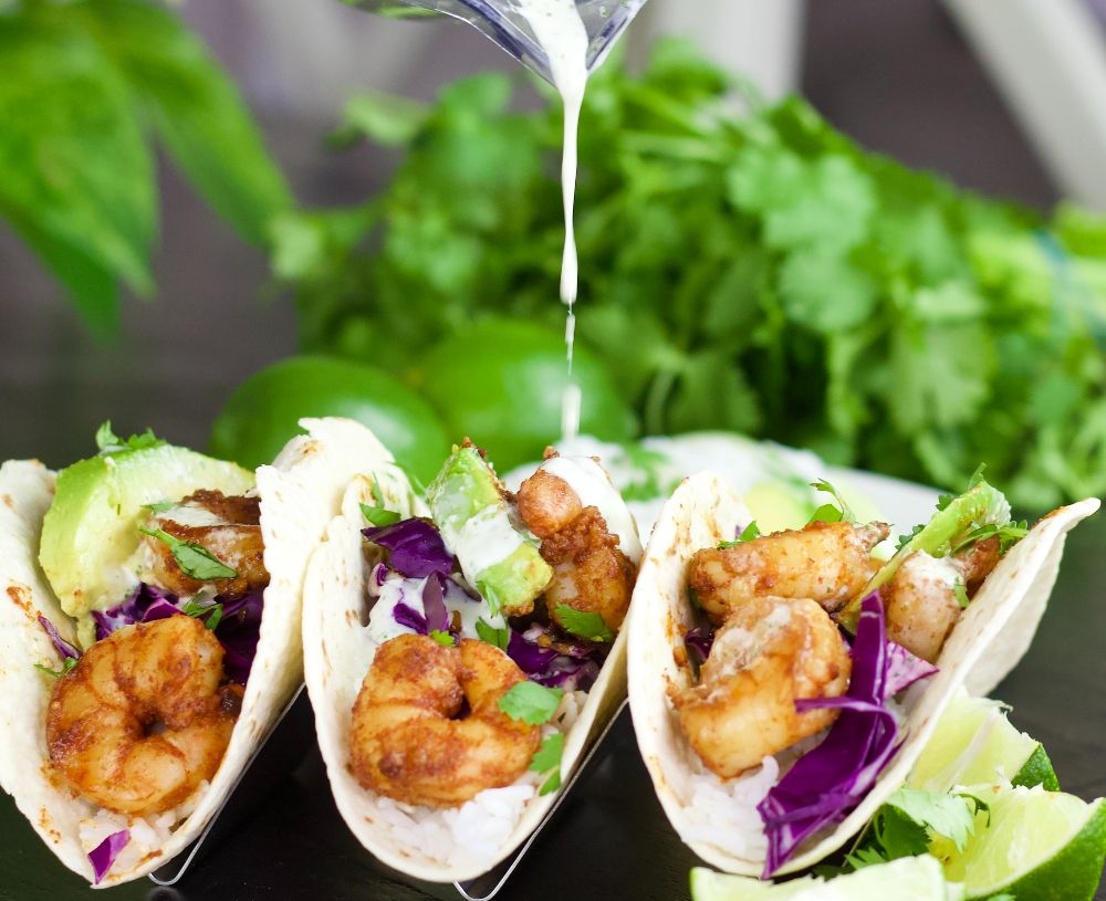 drizzling shrimp tacos with sauce