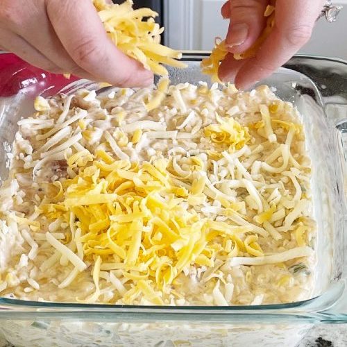 sprinkling cheese on top-corn dip