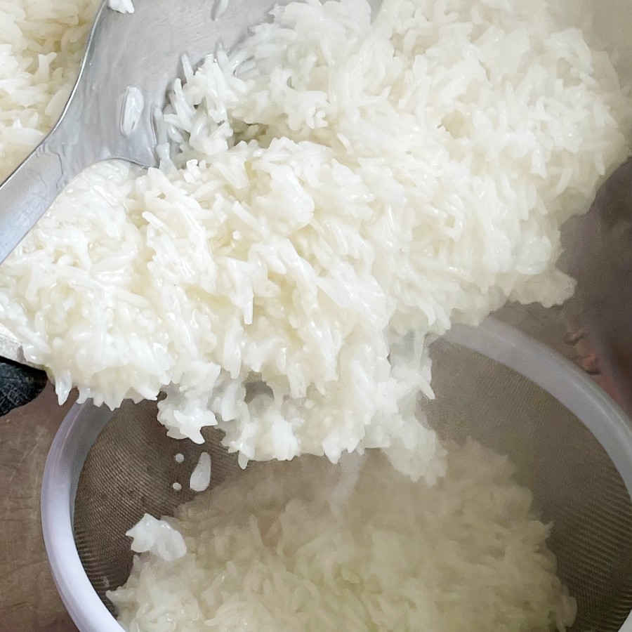 straining cooked rice