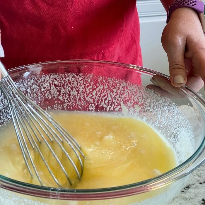 whisking lemon zucchini bread batter