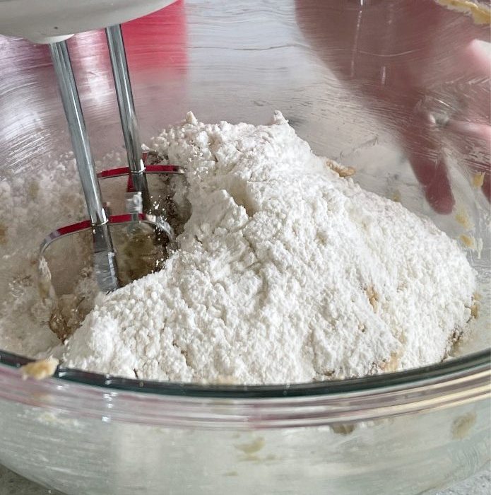 mixing dry ingredients into wet-dark chocolate chip cookies