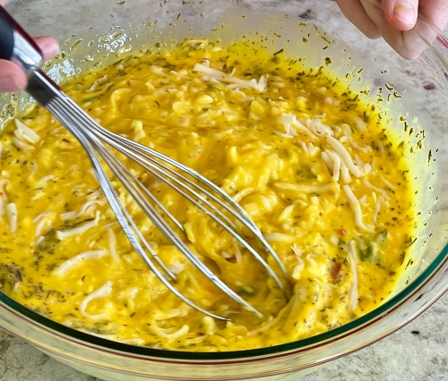 mixing up a spinach and bacon quiche