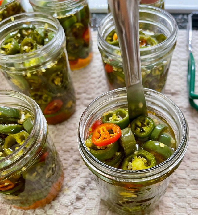 removing air pockets with a knife-canning candied jalape&ntilde;o