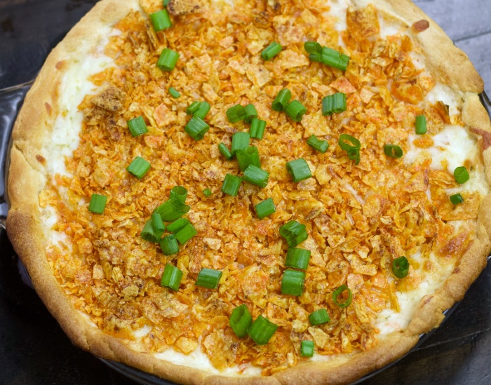 Dorito pie with green onion garnish