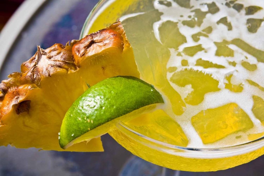 garnished pineapple margarita top view