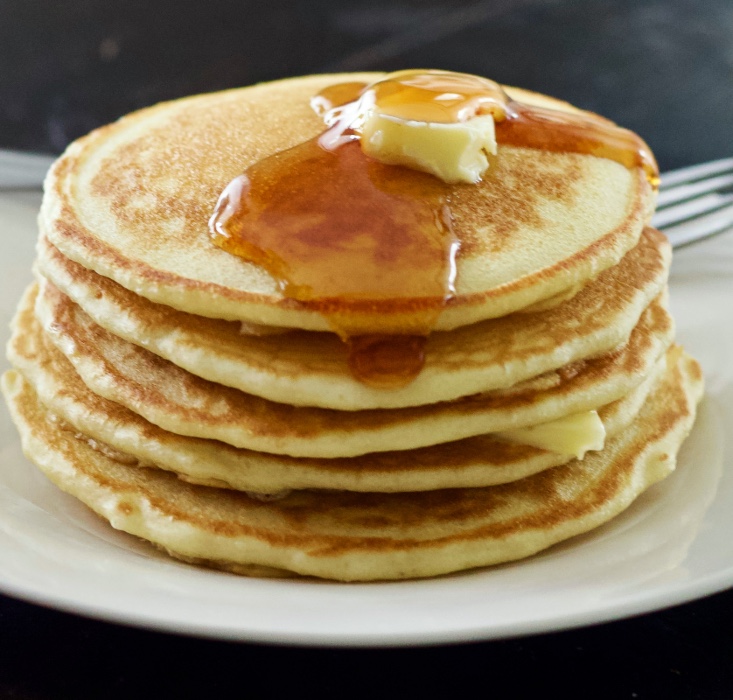 stack of sourdough pancakes with butter and syrup