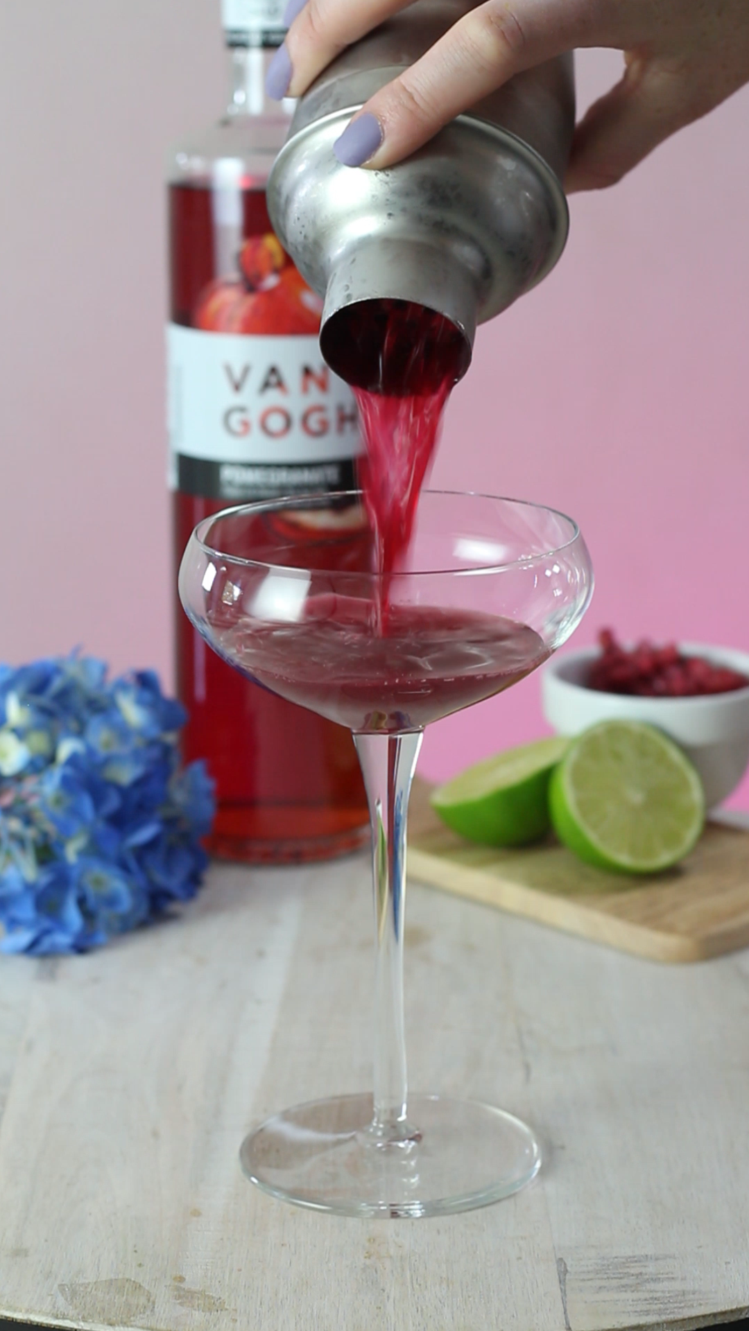 pouring pomegranate blueberry cocktail
