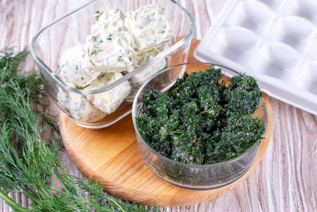 herbs frozen in butter and herbs frozen in water. Ice cube tray method