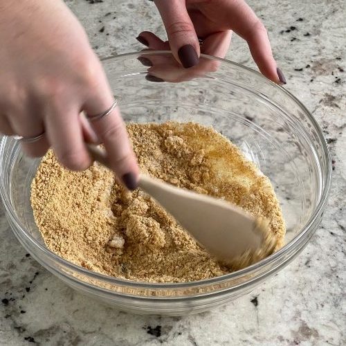 mixing a graham cracker crust