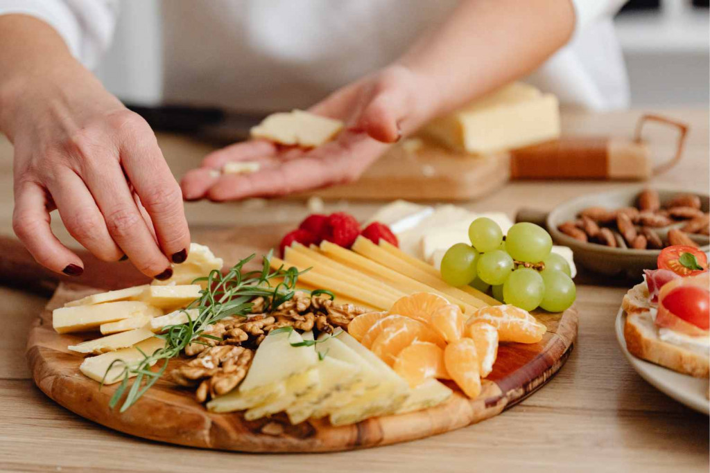 assembling a cheese and fruit tray